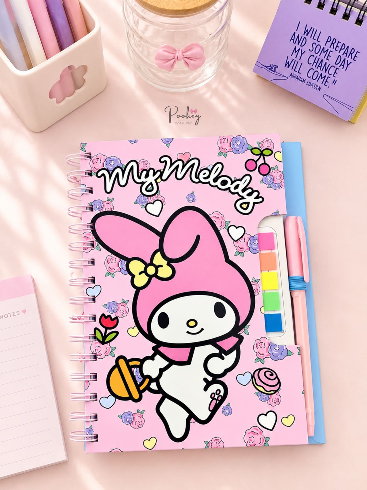 Spiral notebook with pen and sticky note tabs